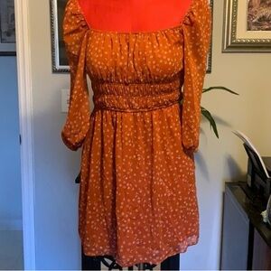 Rust dress that can be worn on the edge of shoulders or as a cold shoulder dress